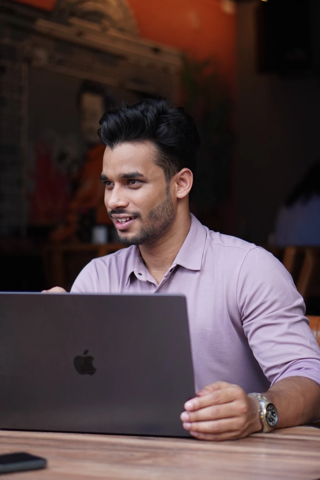 Rahul Manhar working on a laptop at a café