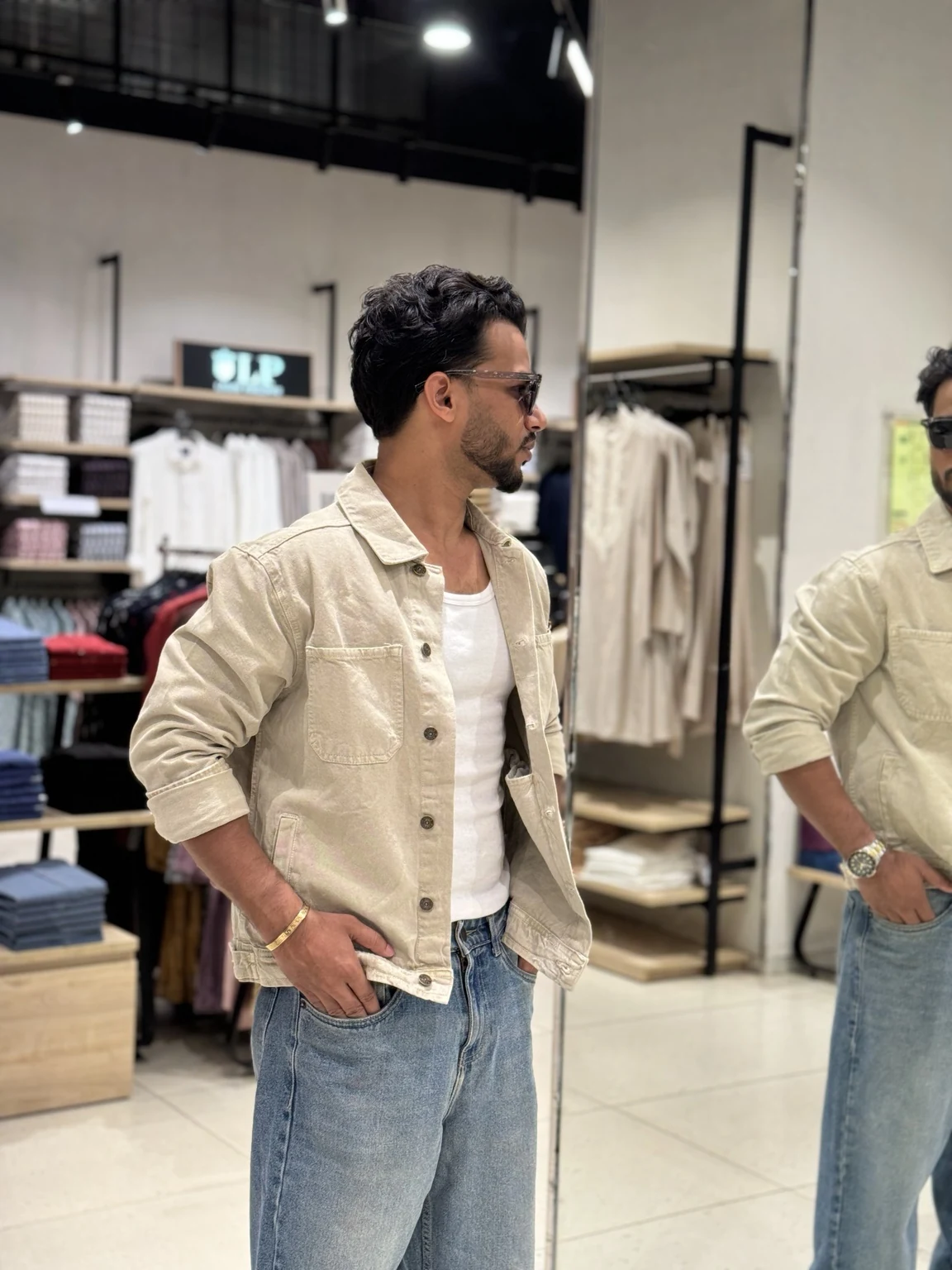 Rahul in a neutral overshirt and denim